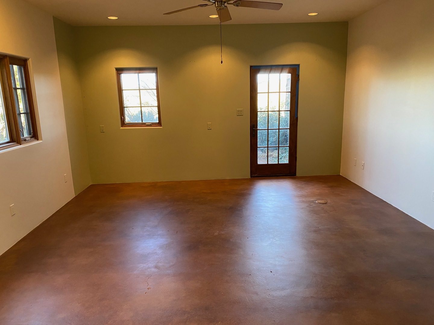 Photo of the same studio room after application of English Red and Coffee Brown EverStain acid stains, showing a warm and inviting change in the room's appearance