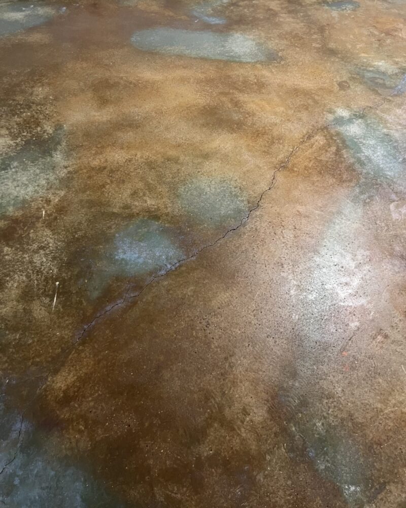 Image of the same room after renovation, showcasing the new acid-stained concrete floor in Malayan Buff and Seagrass