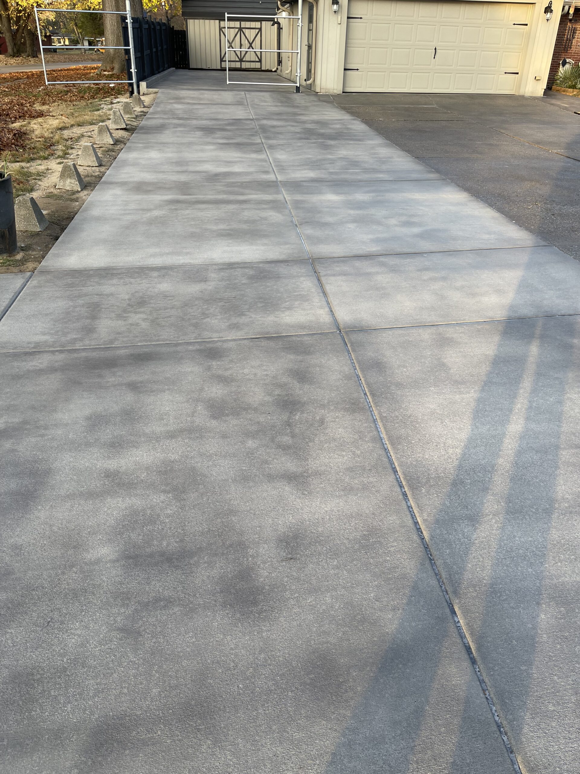 Broomed concrete driveway after being stained with Light Charcoal Antiquing, showing a rich and even color enhancement.