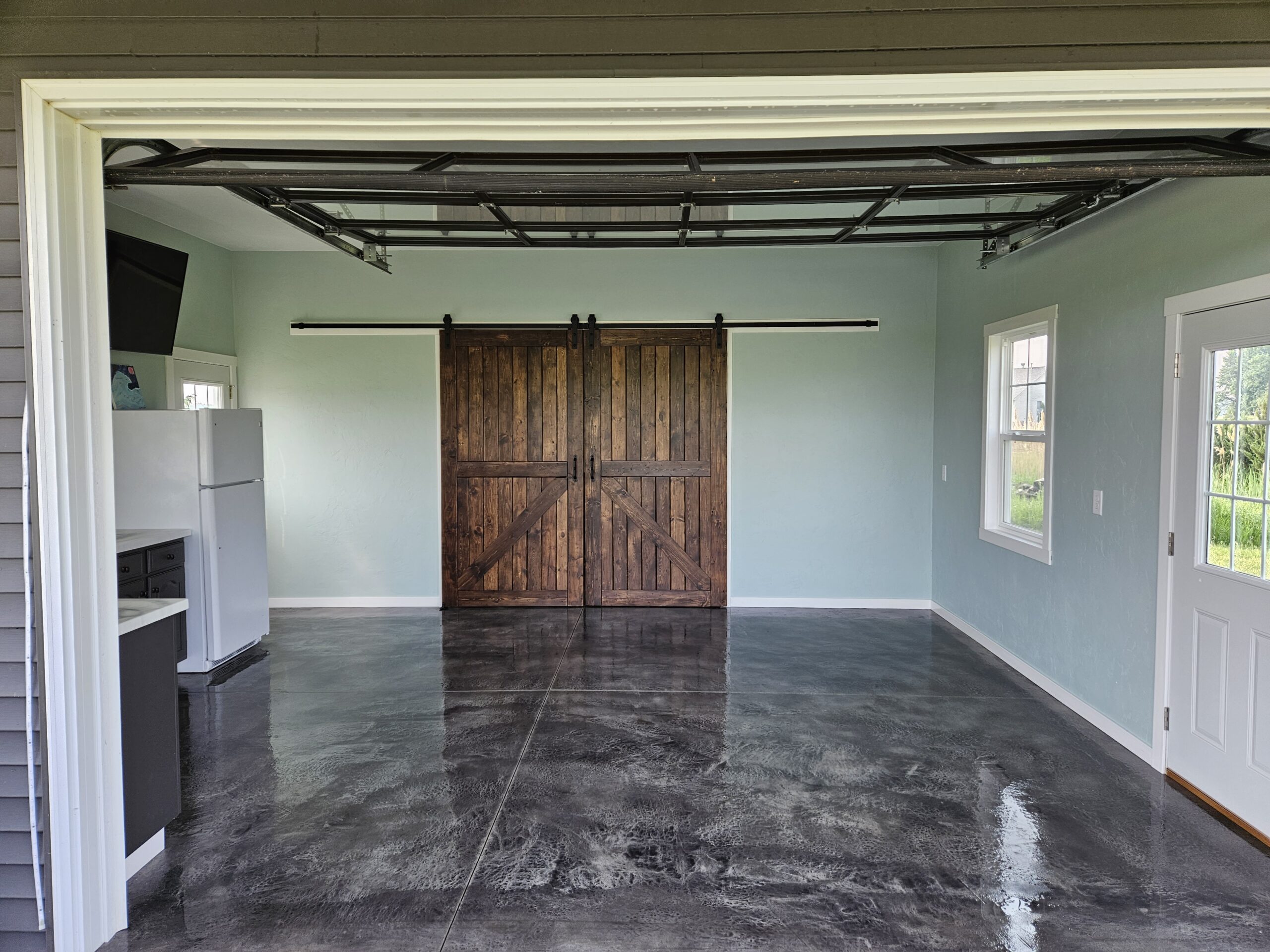 Finished garage showcasing the beautiful, textured and stained concrete floor