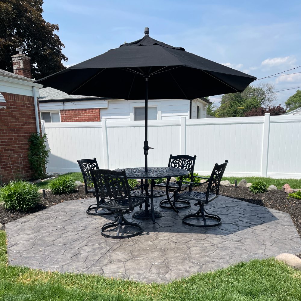 Revived patio after application of antiquing stain and gloss sealant