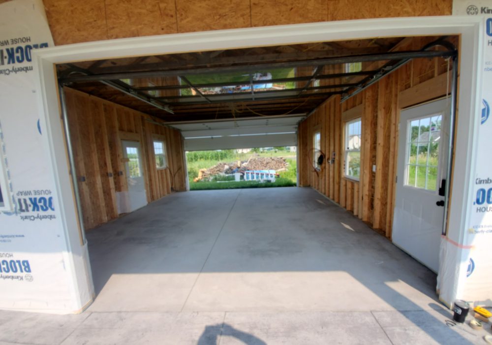 Unfinished concrete garage floor prior to staining