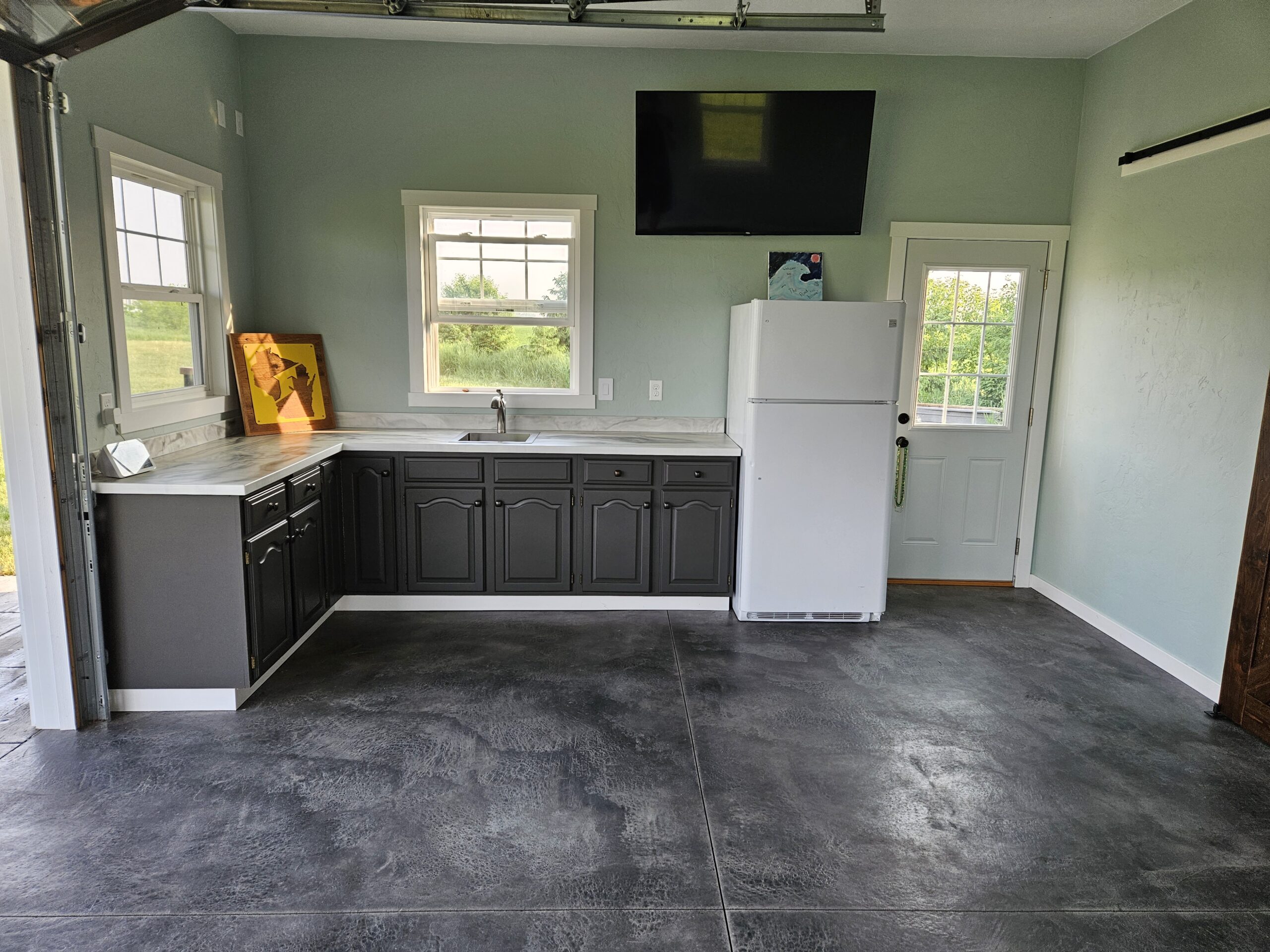 View of the finished garage highlighting the installed kitchen countertops