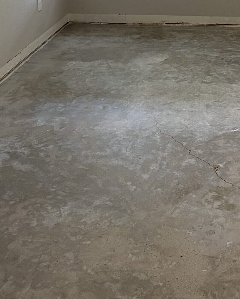 Image of a room with bare concrete floor, prior to acid staining.