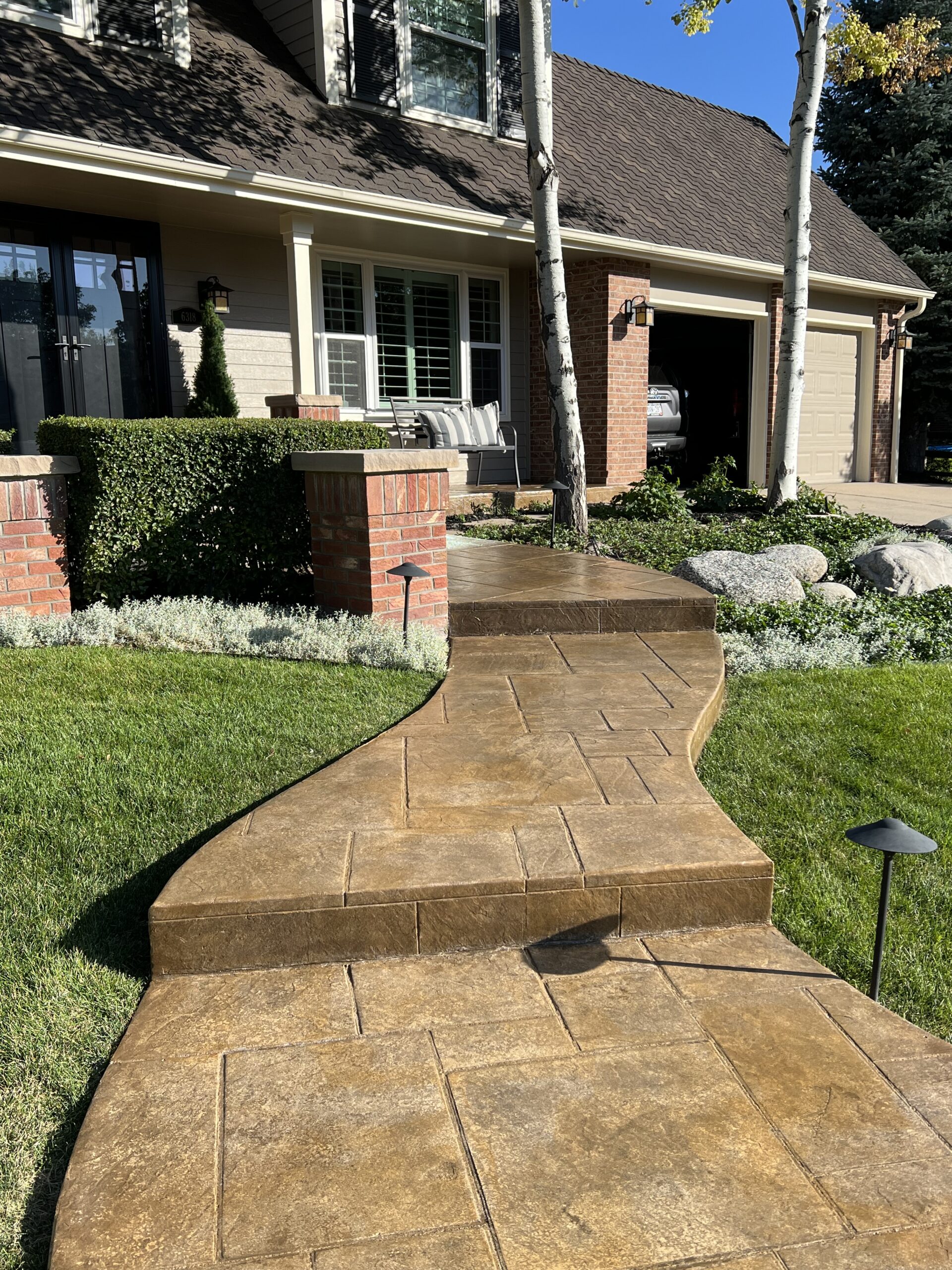 Stamped concrete front porch walkway colored with EasyTint Tweed