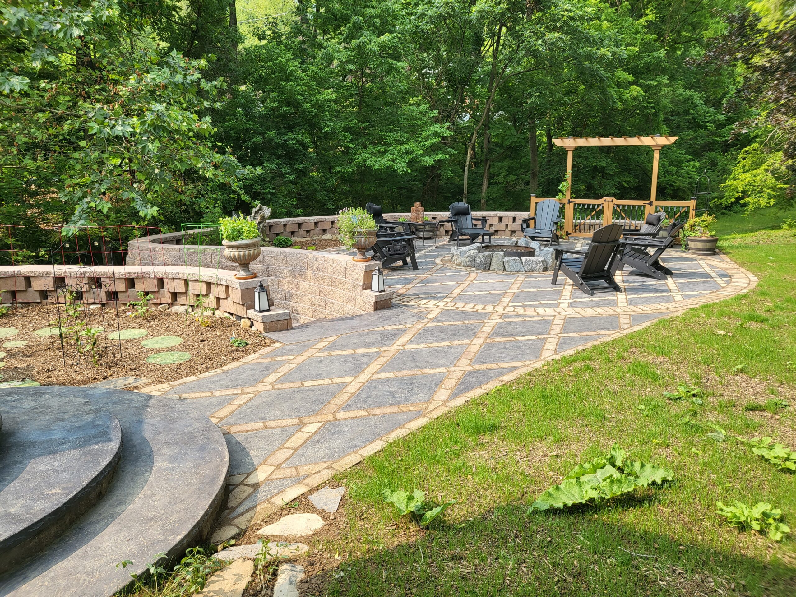 Antiquing light charcoal stained concrete diamonds, complemented by moss-inspired garden stepping stones