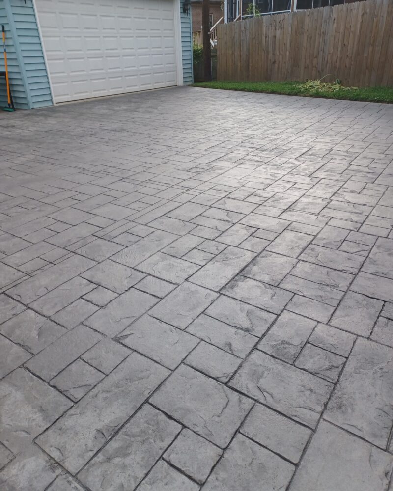 Ashlar slate stamped concrete driveway after Light Charcoal Antiquing application