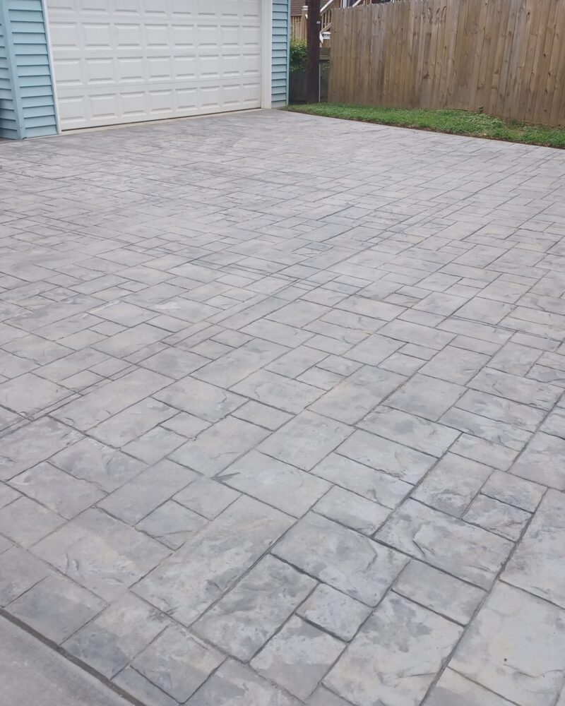Cleaned ashlar slate stamped concrete driveway with visible splotchy clearcoat