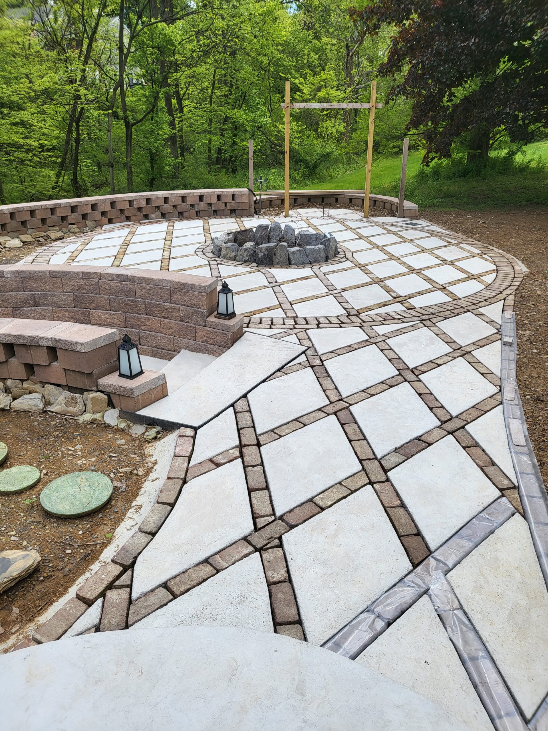 Pre-stained patio with reclaimed bricks and a harlequin diamond pattern unfinished concrete pavers