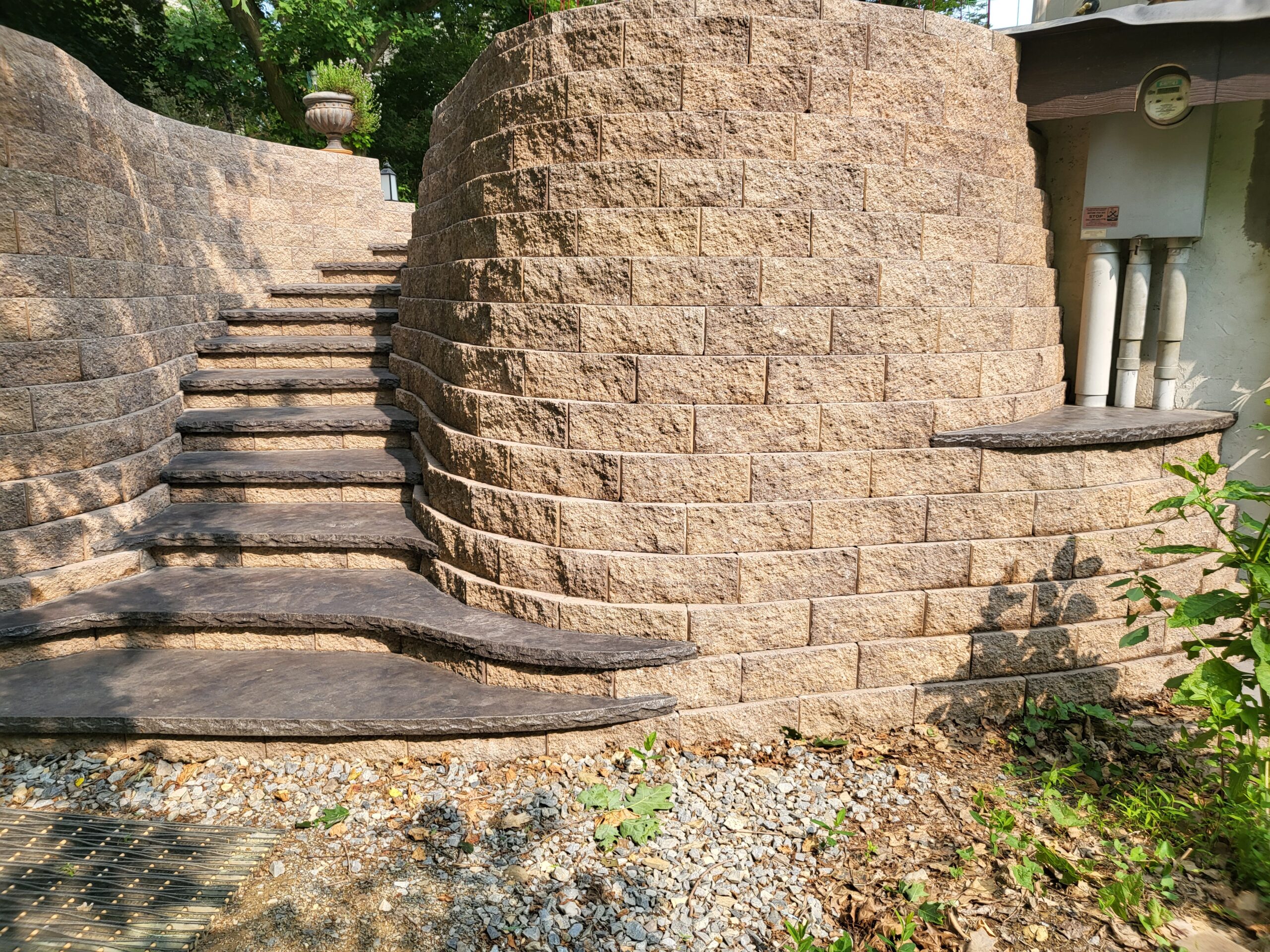 Stained retaining wall and steps in Antiquing Light Charcoal outdoor concrete stain leading into the patio extension