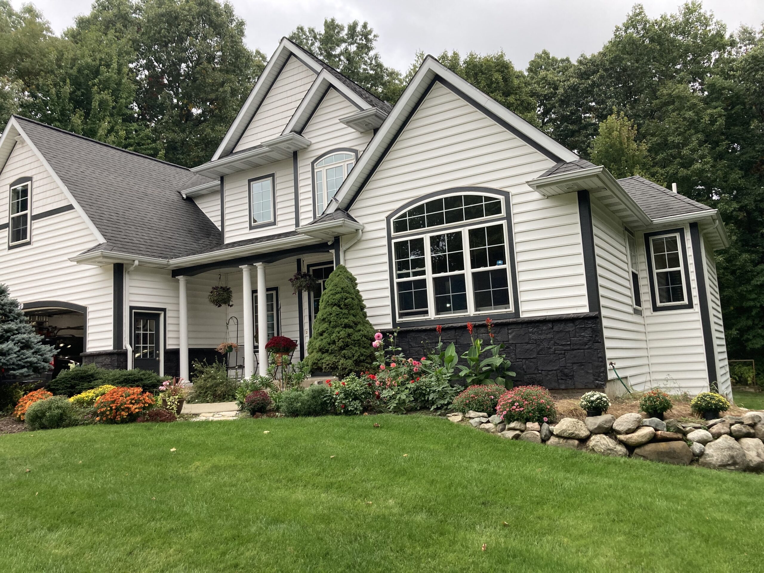 Full view of the house showcasing its finished black Portico stone facade transformation
