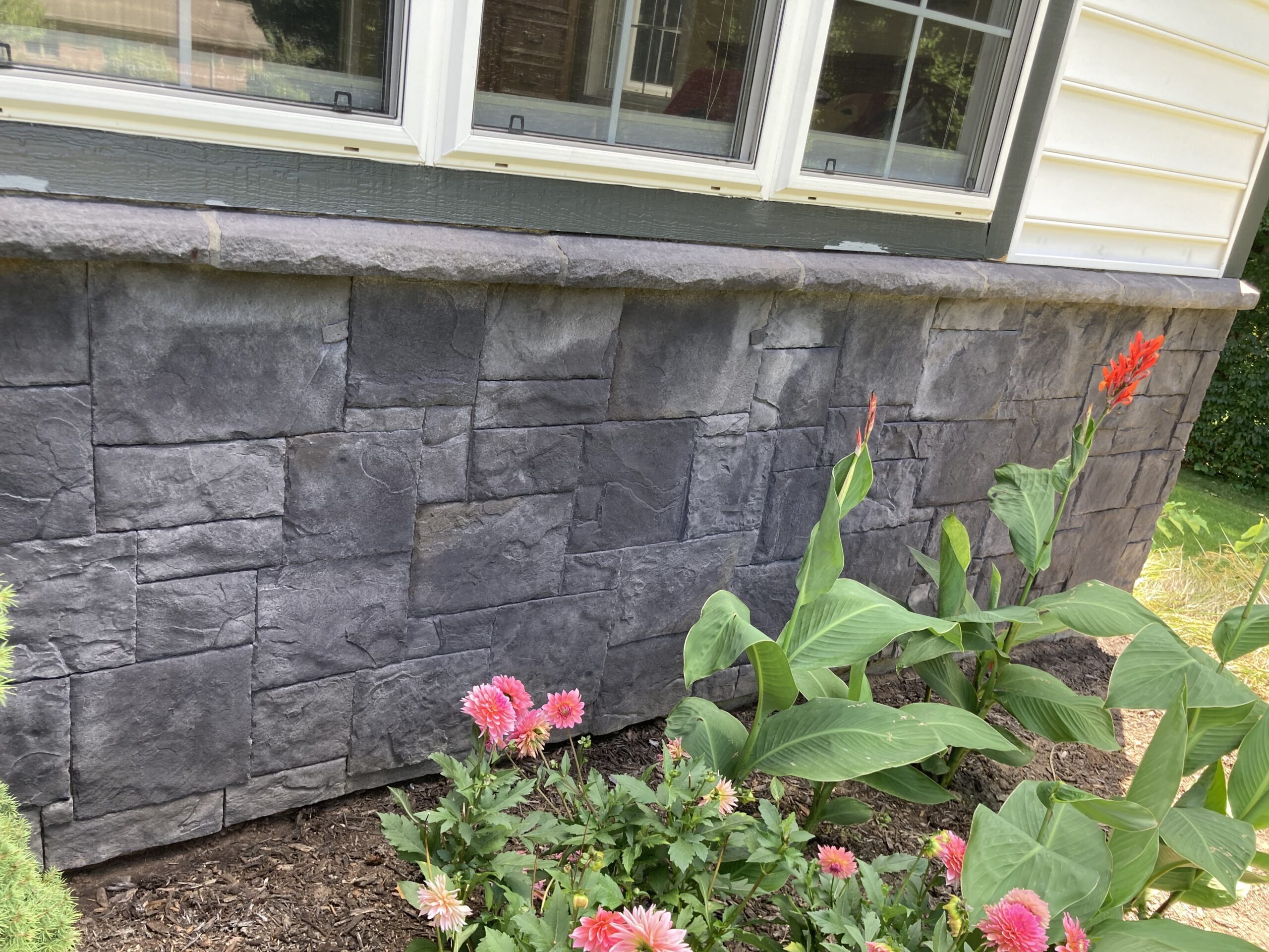 House facade after the first coat of black Portico stain, showing a darker shade