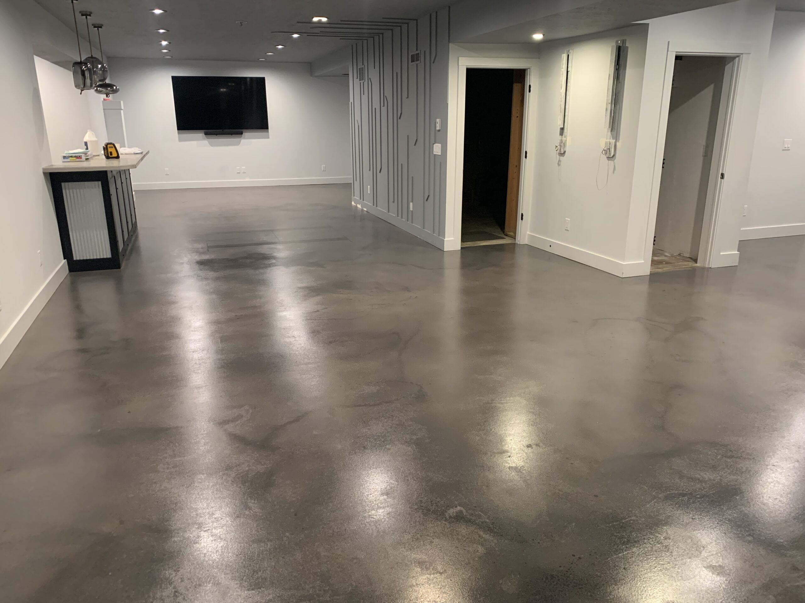 A basement floor with a smooth, polished appearance after the application of the second coat of AcquaTint stain