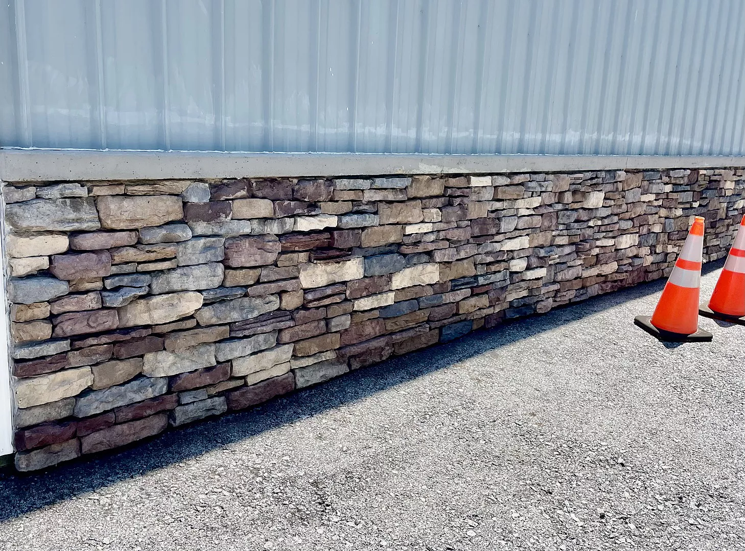 Stone veneer foundation after restoration with Auburn, Khaki, Charcoal, and Driftwood Portico Stains and sealed with EasySeal, revealing natural stone depth and color variation.