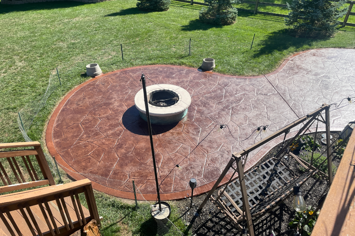 Stamped patio restored with Aztec Brown stain and Russet border, featuring even color and soft satin sheen.