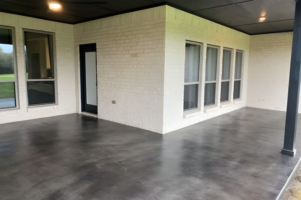 Back concrete patio freshly stained with Black Antiquing for a modern appearance