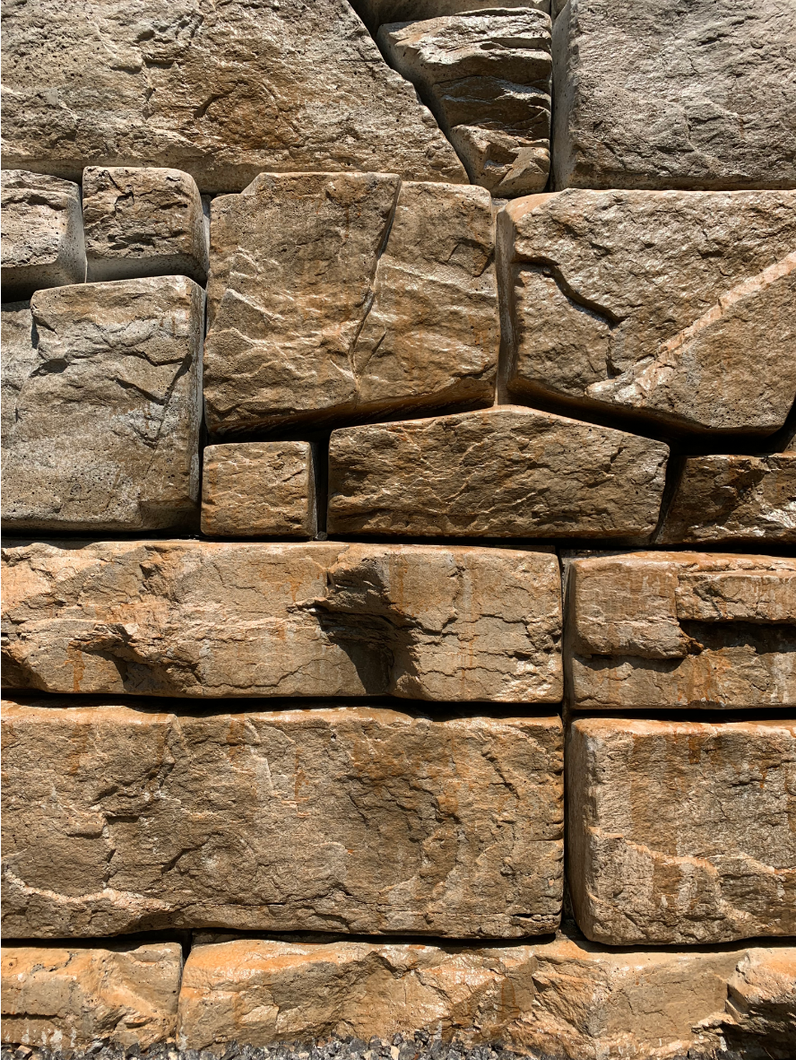 Retaining wall finished with Café Royale EasyTint™ Satin, showing rich brown tones and natural stone texture