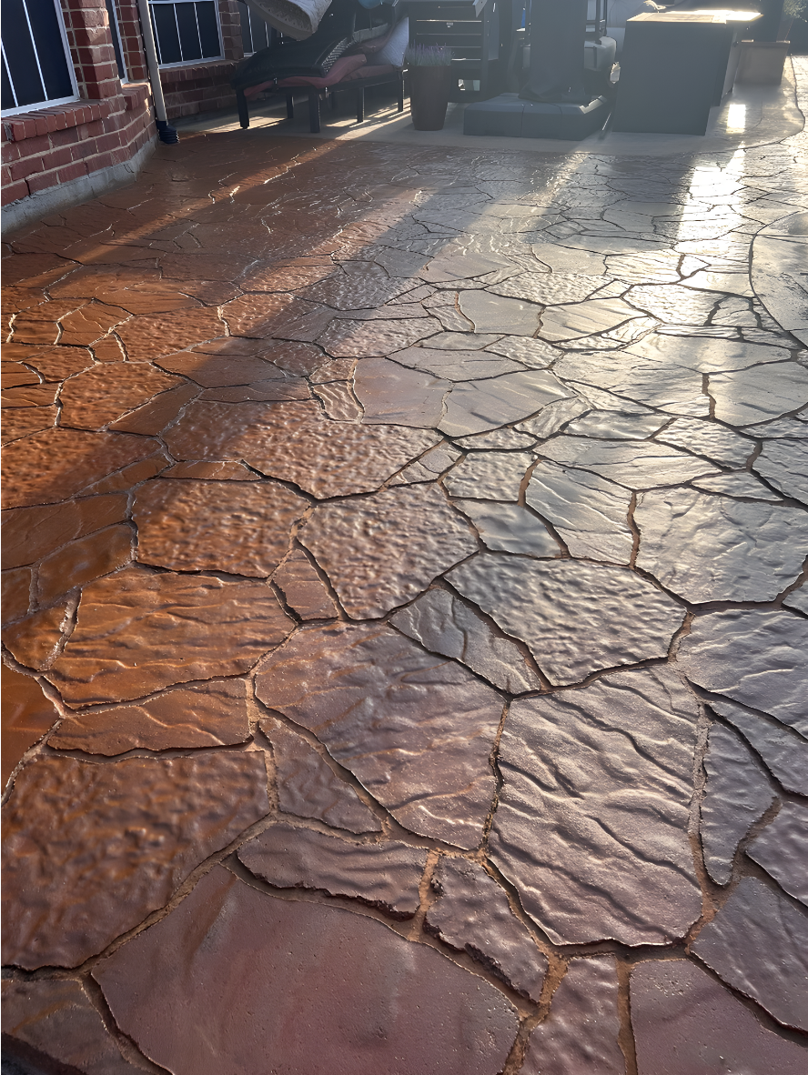 Stamped concrete patio restored with Aztec Brown stain and Maple EasyTint™ sealer, featuring a warm, glossy tone and durable finish