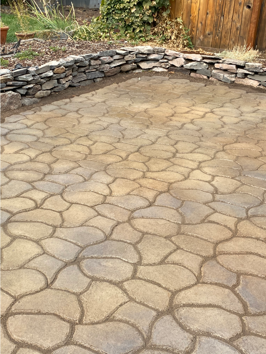 Stamped concrete patio finished with Café Royale, Olive, and Charcoal Antiquing™ Stains, featuring rich, layered tones that mimic natural stone.