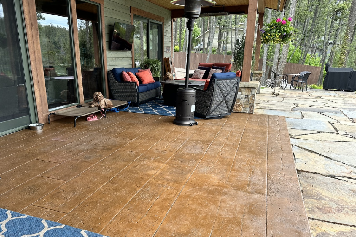 Wood-grain stamped concrete patio stained with Café Royale EasyTint™, featuring rich brown tones and a satin finish.