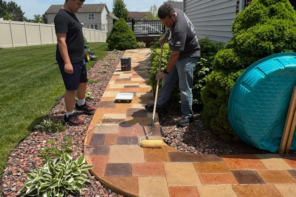 First coat of EasySeal Gloss being rolled onto Auburn, Khaki, Terracotta and Yukon Gold stained concrete for color enhancement.