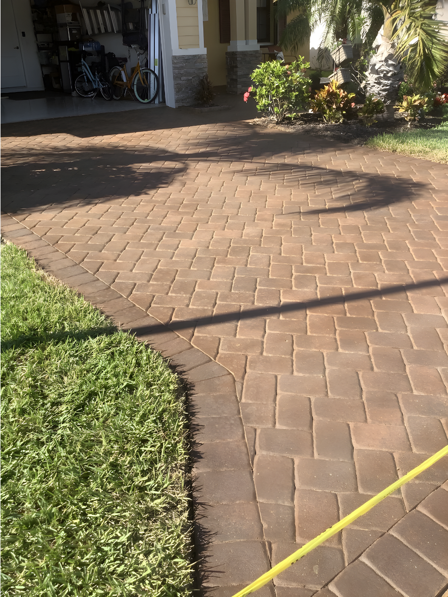 Full view of a paver driveway stained in Café Royale, highlighting a rich, natural tone and restored finish.