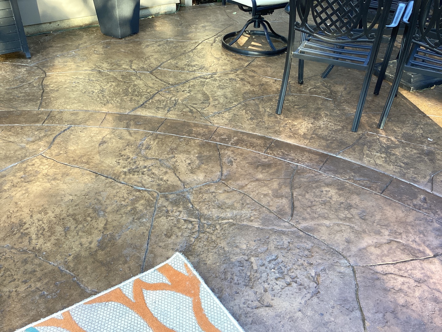 Faded stamped concrete patio before EasySeal Gloss application.