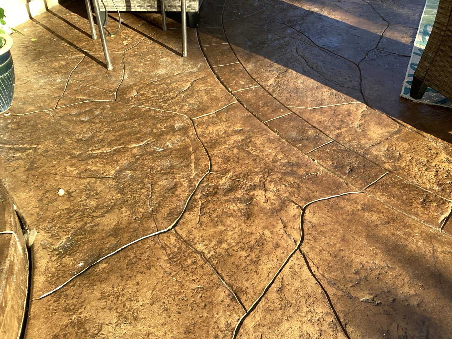 Stamped concrete patio after EasySeal Gloss application with richer brown color and enhanced texture.
