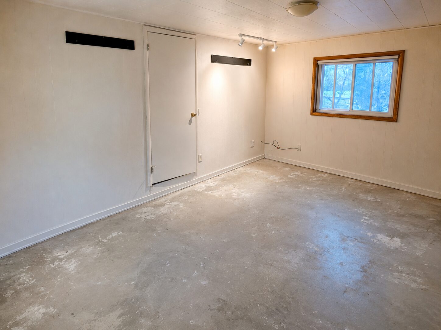 Bare concrete floor in a converted garage before applying ColorWave Amber stain.
