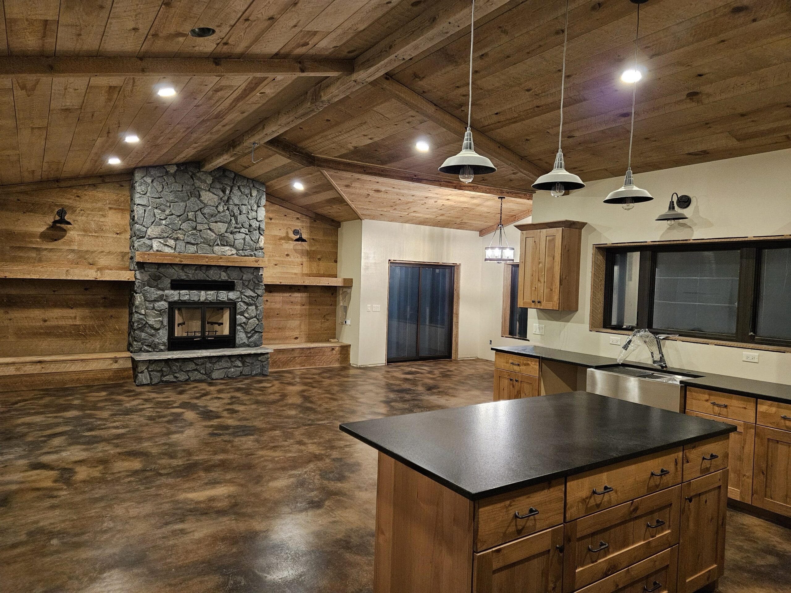 Rustic kitchen and living area with EverStain Coffee Brown and Desert Amber acid-stained concrete floor sealed with AcquaSeal Satin, creating a warm leather-like finish.