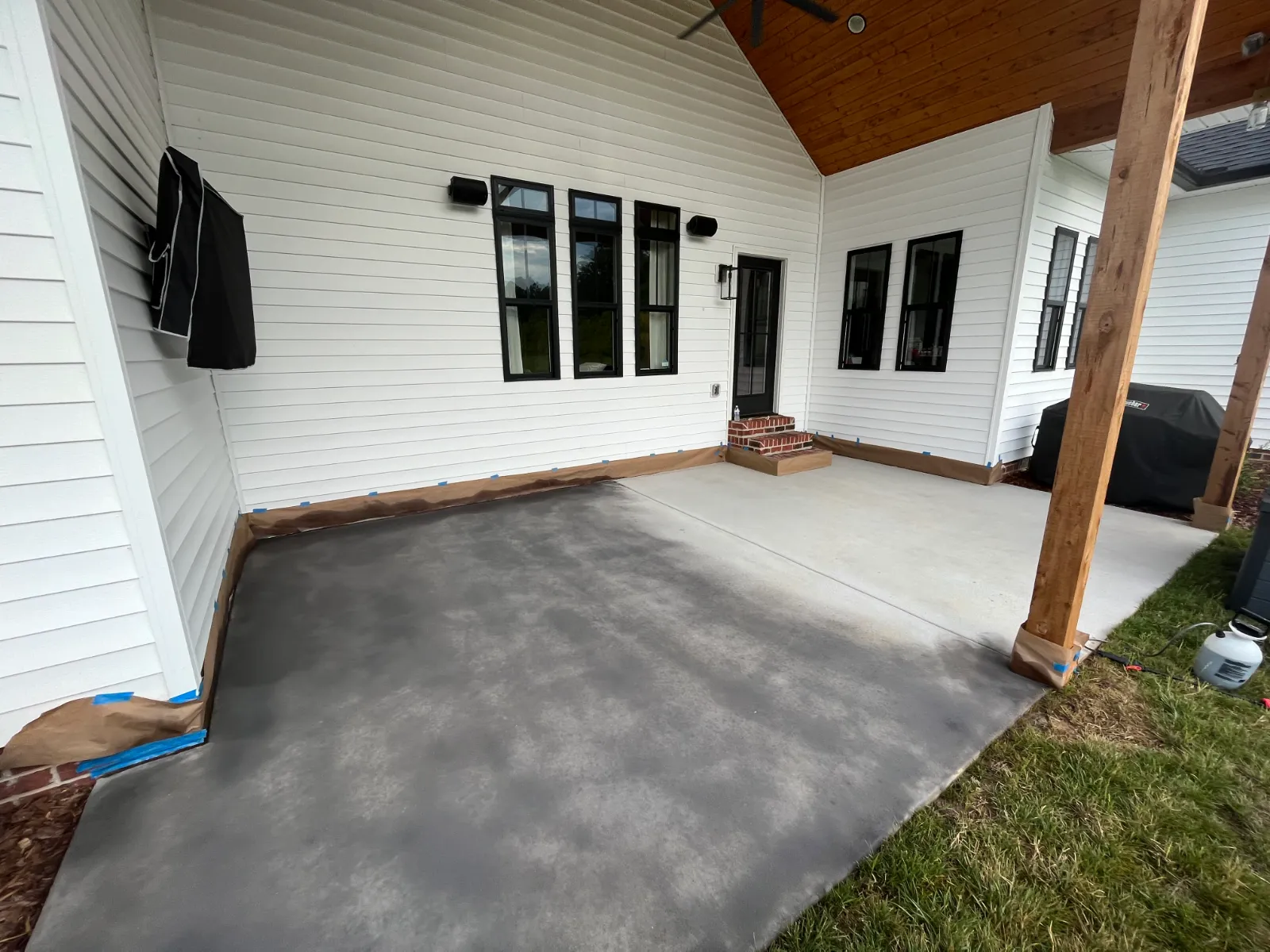 Silver Gray Antiquing Stain being applied to a broom-finish covered concrete patio