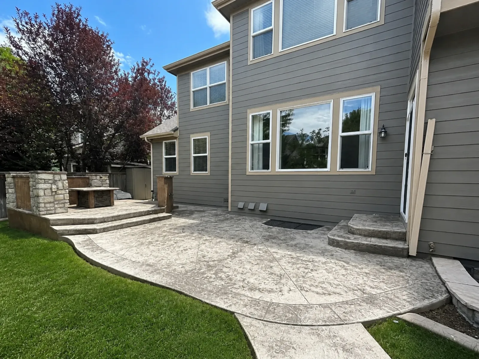 Faded stamped concrete patio with discoloration and efflorescence before restoration.