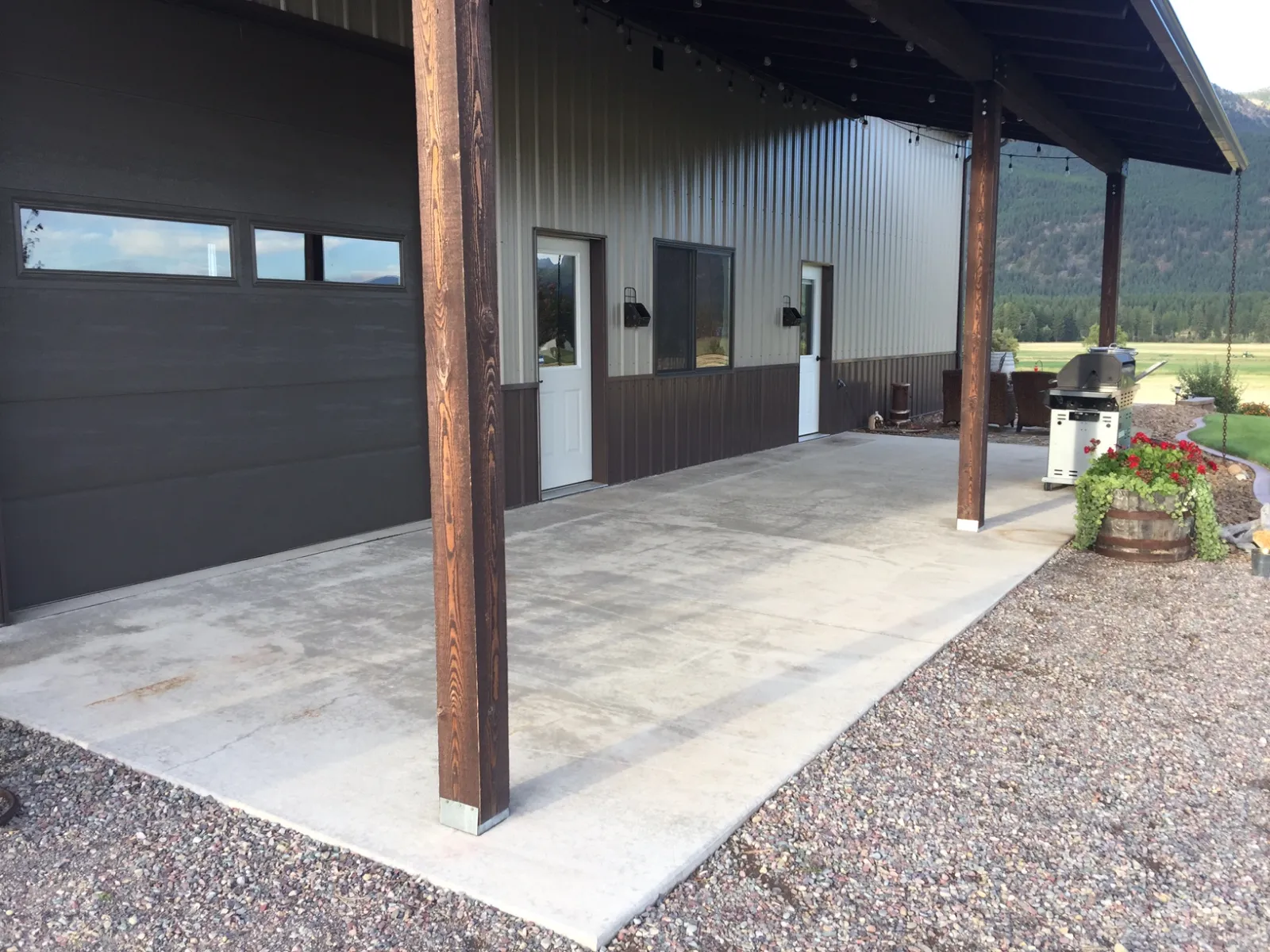 Unstained smooth concrete patio outside a pole barn before applying Driftwood Antiquing Stain