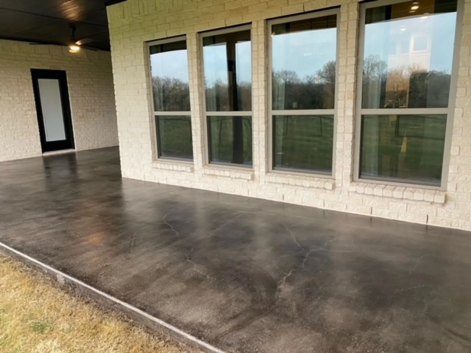 Alternate view of a new smooth concrete covered patio transformed with Black Antiquing Stain and a protective topcoat.