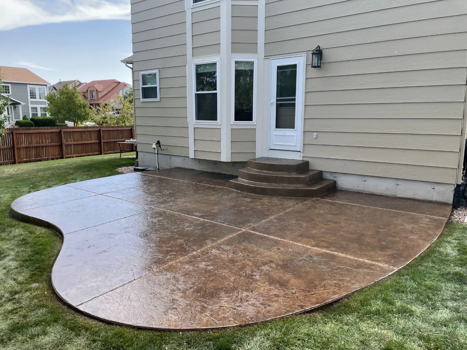 Restored Colorado stamped concrete patio finished with Driftwood Antiquing Stain and satin acrylic sealer.