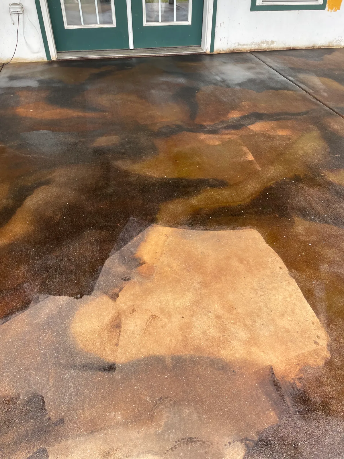 Covered concrete patio after Coffee Brown, Malayan Buff, and Desert Amber acid after stain application, during sealing