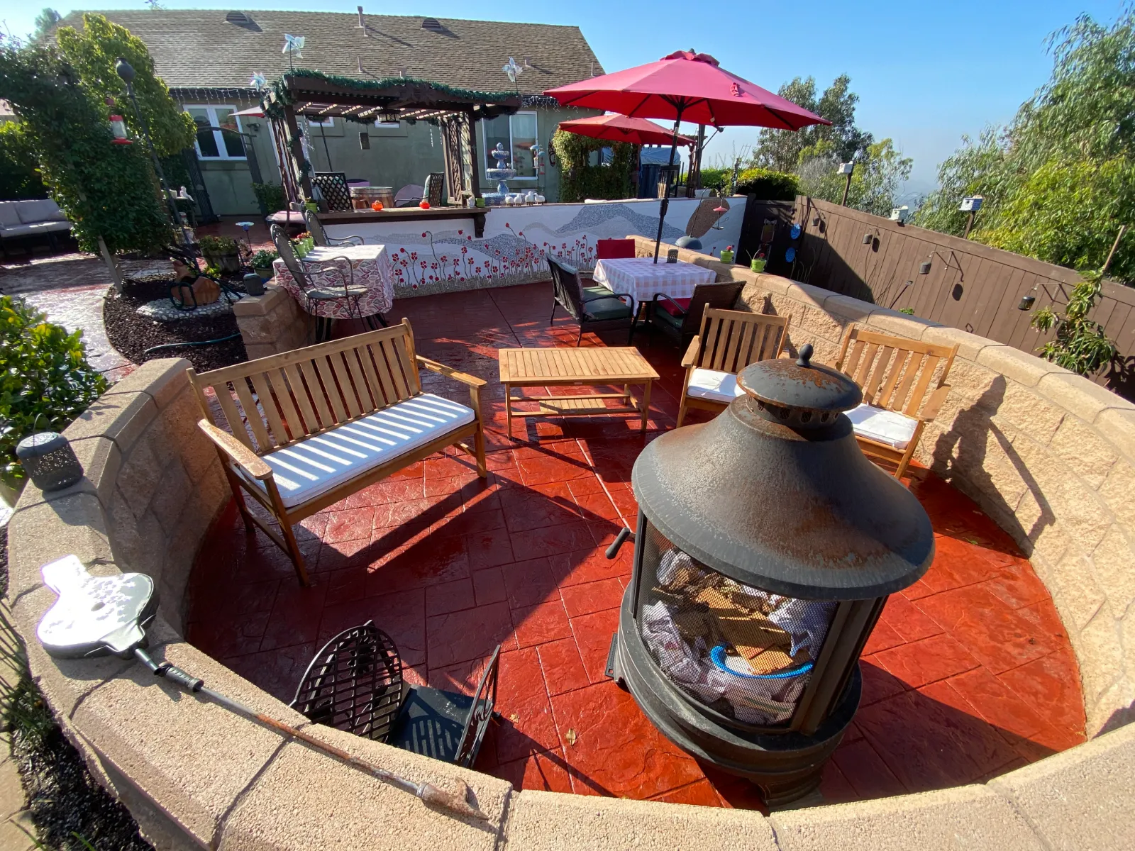 Faded integrally colored stamped concrete patio restored to a vibrant red with Crimson Antiquing Stain.