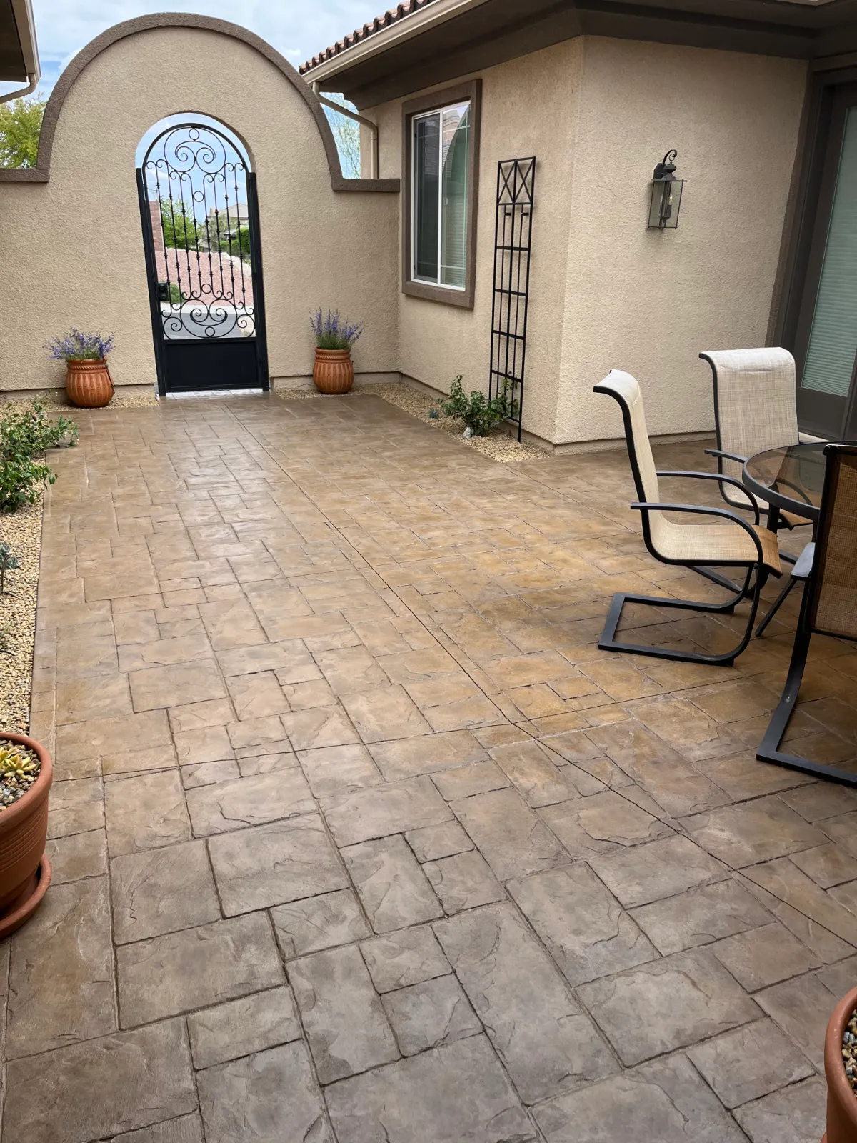 Mediterranean-style stamped concrete courtyard restored with warm, variegated Tweed Antiquing Stain.